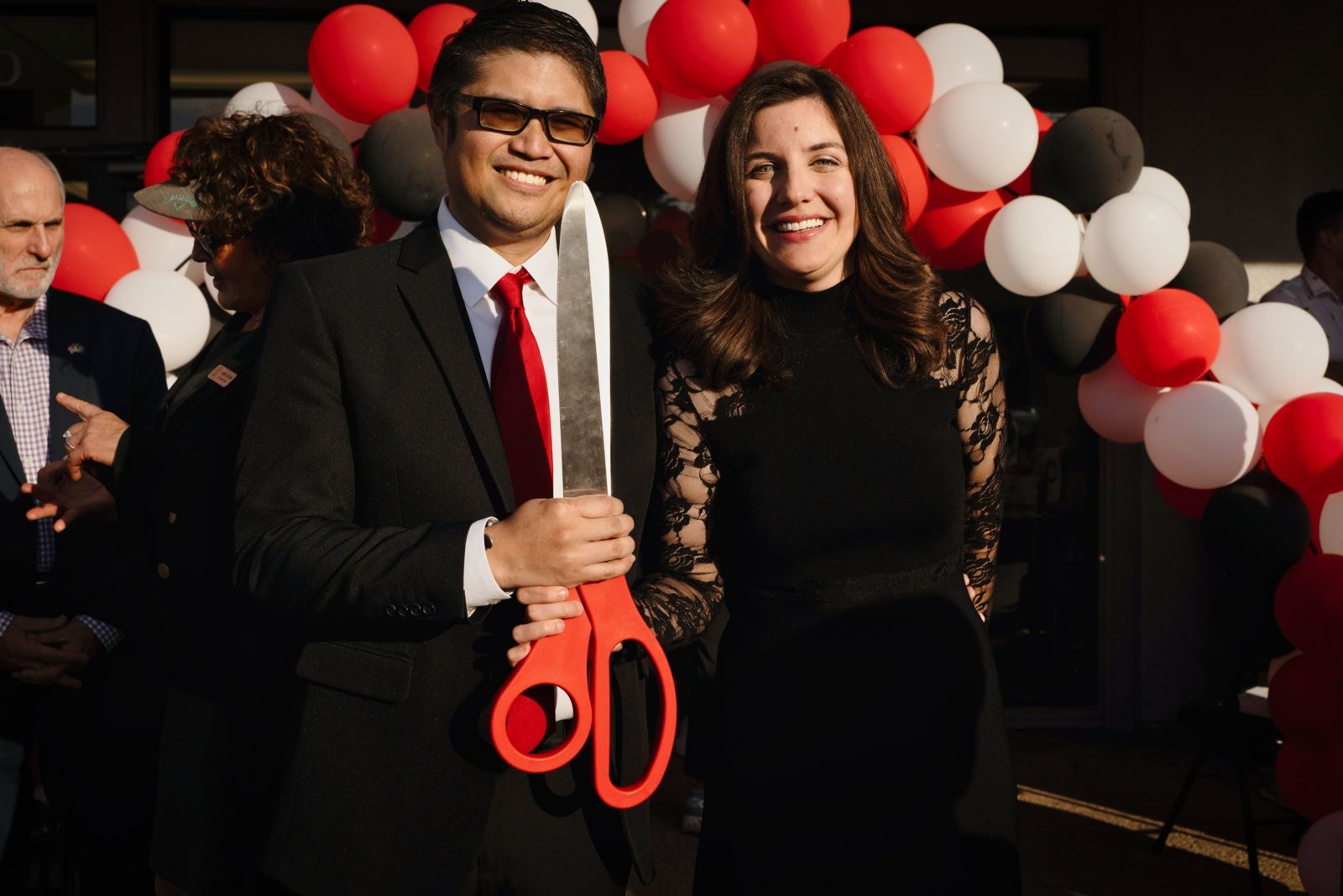 Mark and Kareen Ignacio holding scissors at Ribbon-Cutting Ceremony | San Diego estate planning attorney