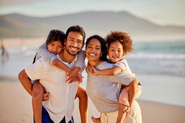 Young family of four at the beach