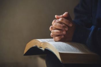Man praying for a faith-based estate plan