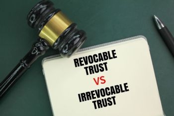 Judge's hammer, pen and book with the words Irrevocable Trust vs Revocable Trust 